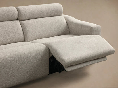 Close-up of the light gray textured fabric on the Fia Two-Piece Motion Sofa, featuring two black motion control buttons and a black zipper.