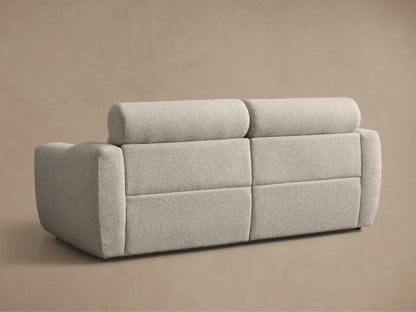 Close-up of the light grey textured Fia Two-Piece Motion Sofa with the right footrest extended.