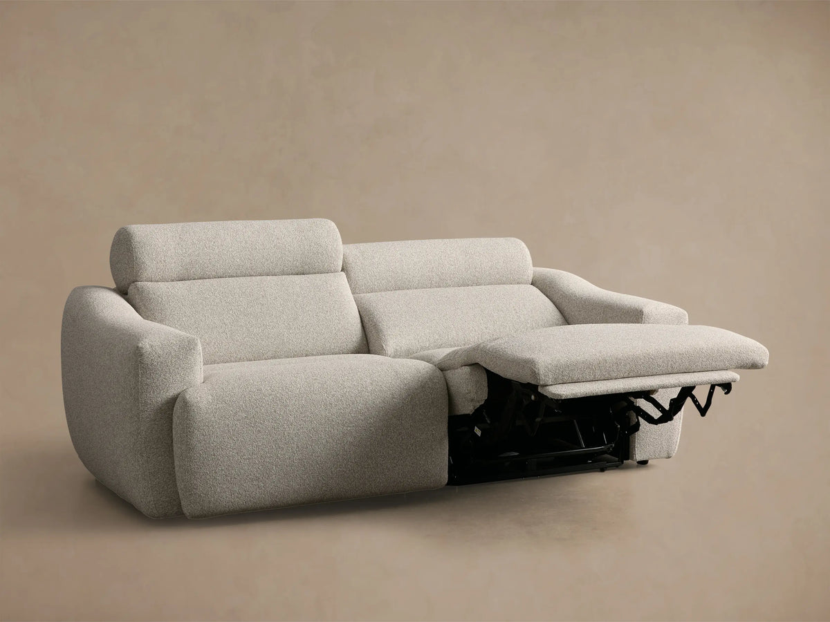 Rear view of light beige Fia Two-Piece Motion Sofa, showing two back sections with textured performance fabric.