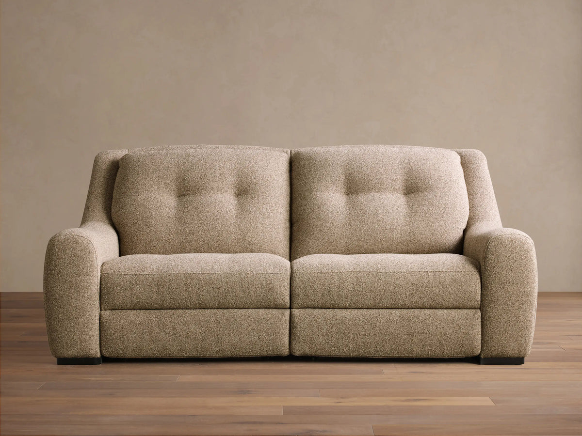 Front view of the light brown speckled Perry Two-Piece Motion Sofa with two tufted backrests and rounded arms.