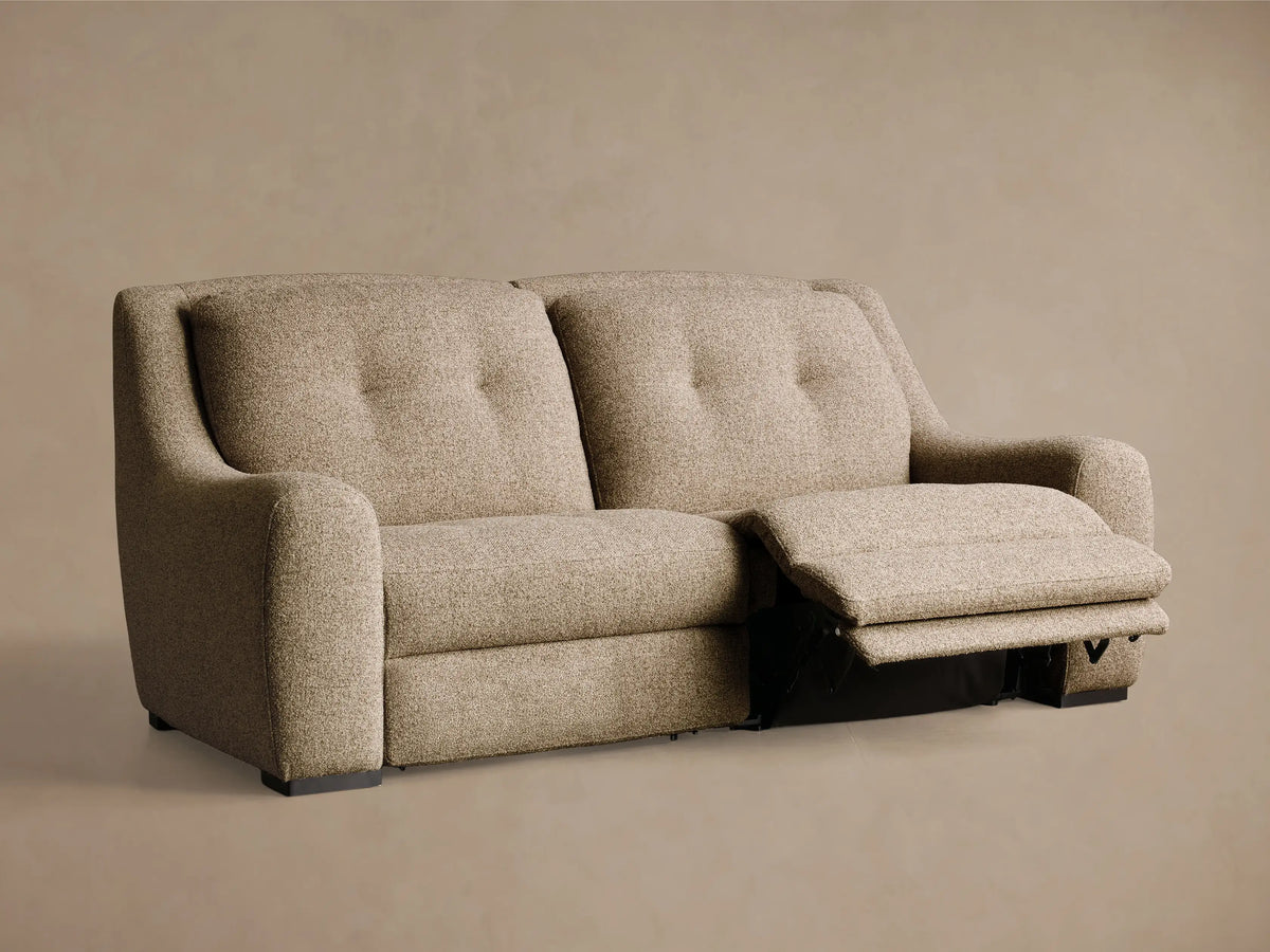 Rear view of the light brown textured fabric Perry Two-Piece Motion Sofa with dark feet.