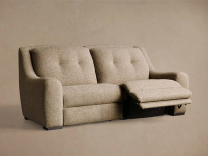 Rear view of the light brown textured fabric Perry Two-Piece Motion Sofa with dark feet.