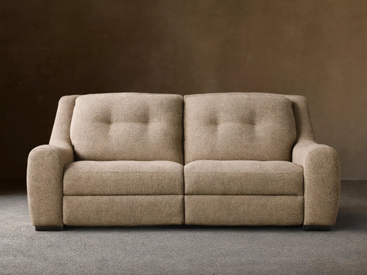 Front view of the light brown speckled Perry Two-Piece Motion Sofa with two tufted backrests and rounded arms.