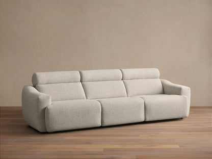 Front view of the light gray Fia Three-Piece Motion Sofa with integrated headrests and textured upholstery.