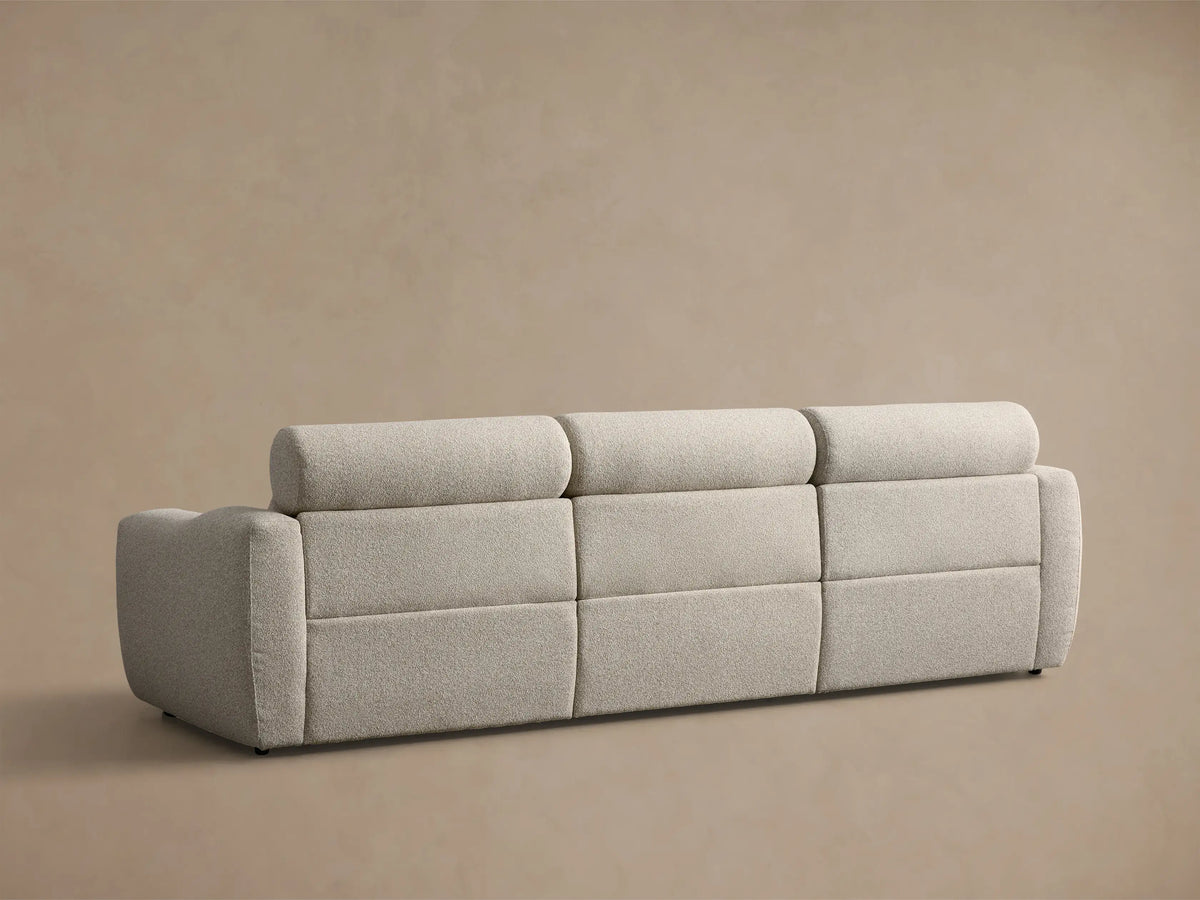 Side view of a light grey textured performance fabric Fia Three-Piece Motion Sofa with a reclined footrest extended.