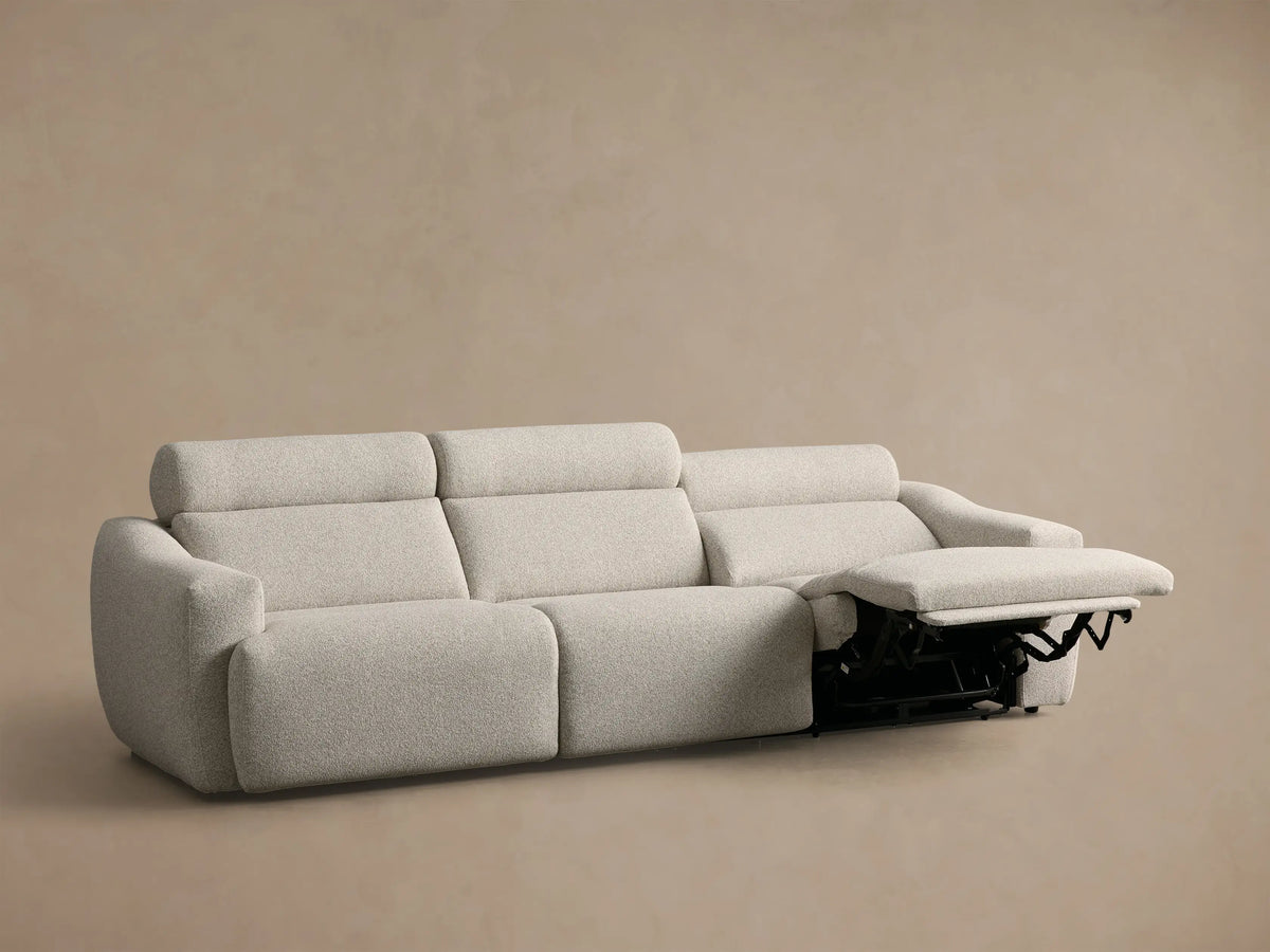 Rear view of the light beige Fia Three-Piece Motion Sofa, showing its three individual seat and back cushions.