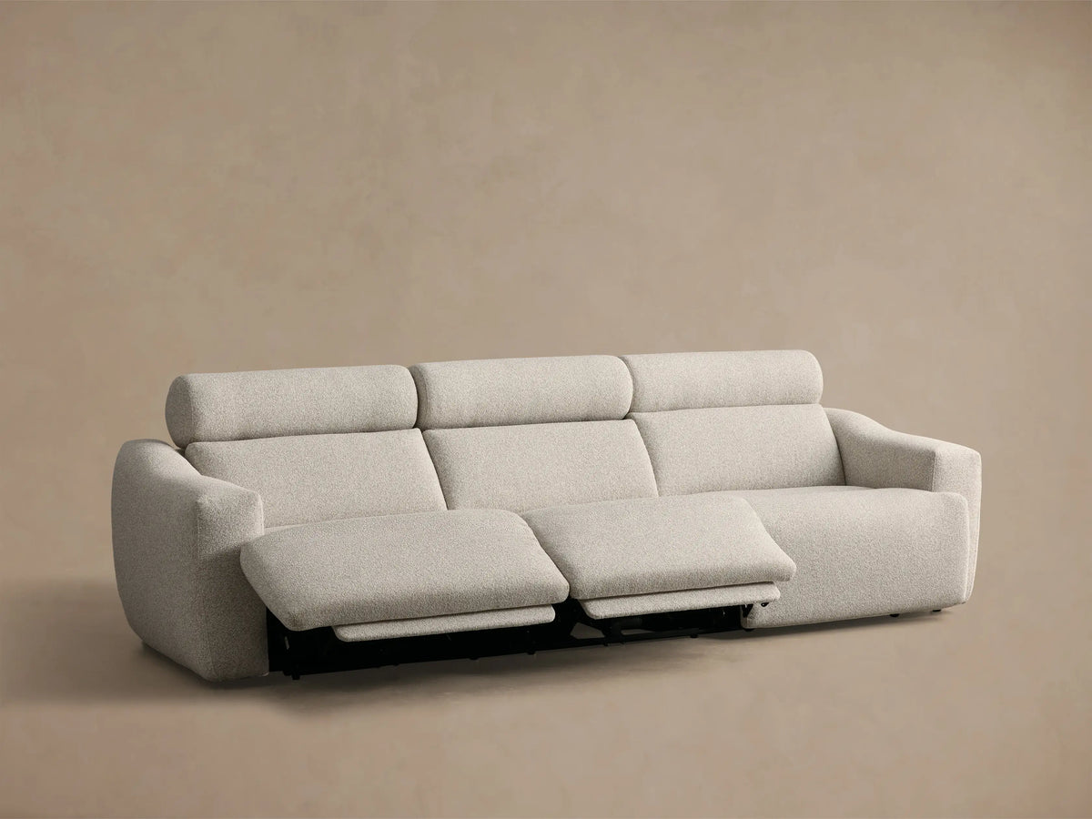 Front view of a light gray textured Fia Three-Piece Motion Sofa with the right footrest fully extended.