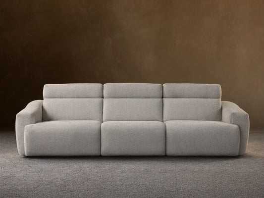 Front view of the light gray Fia Three-Piece Motion Sofa with integrated headrests and textured upholstery.