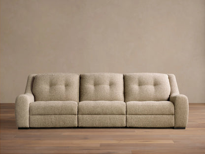 Front view of the light beige textured Perry Three-Piece Motion Sofa, featuring three seats with button-tufted back cushions.