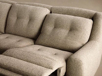 Front 3/4 view of the oatmeal textured Perry Three-Piece Motion Sofa with button tufting on the back cushions and rounded arms.