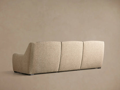 Close-up of three black oval motion control buttons embedded in the light grey textured fabric of the Perry Three-Piece Motion Sofa.