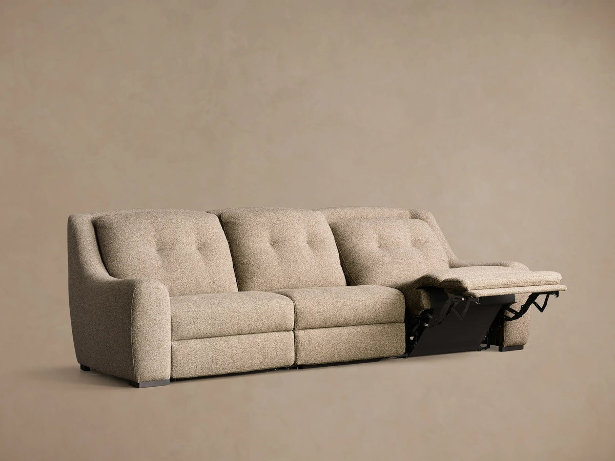 Rear view of the light beige upholstered Perry Three-Piece Motion Sofa, showing its three distinct back sections.