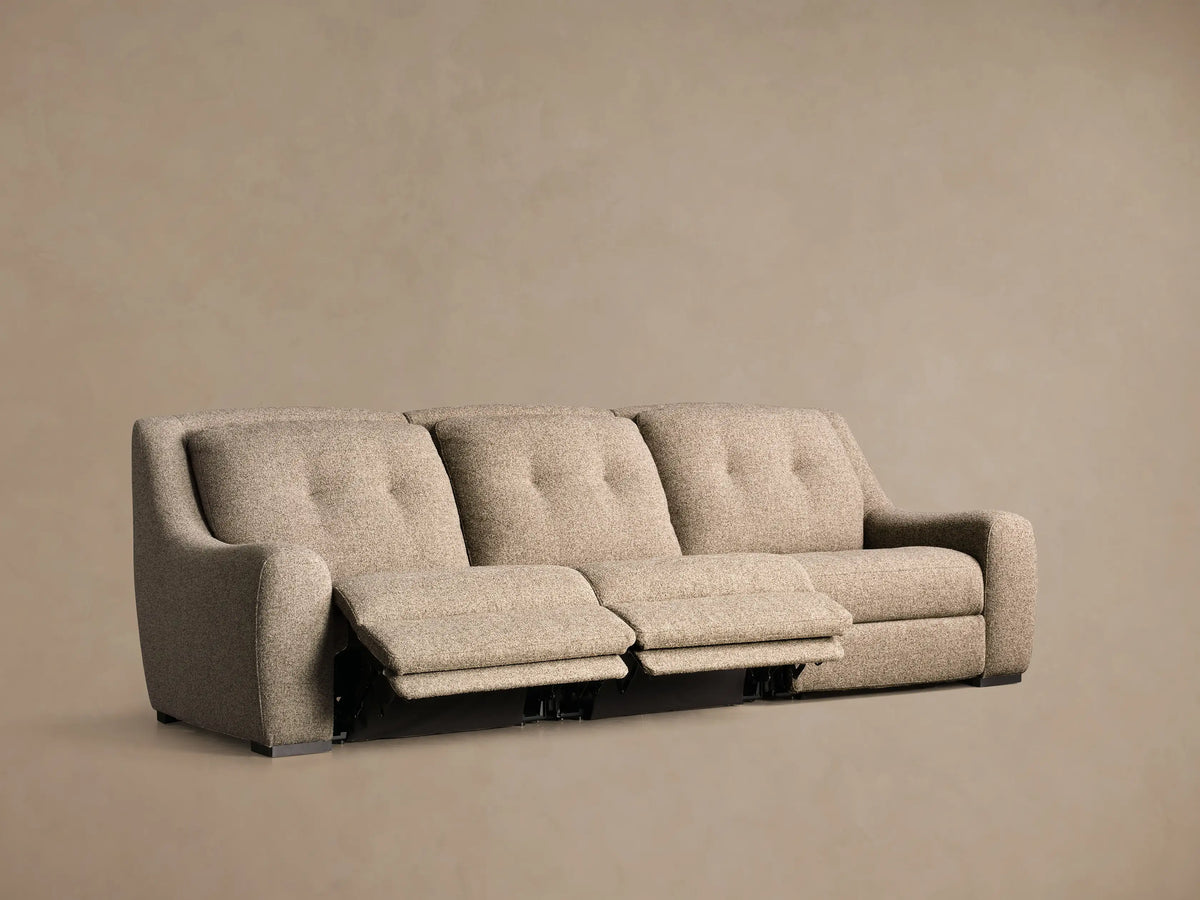 Front view of the speckled beige Perry™ Three-Piece Motion Sofa with the right section fully reclined and footrest extended.