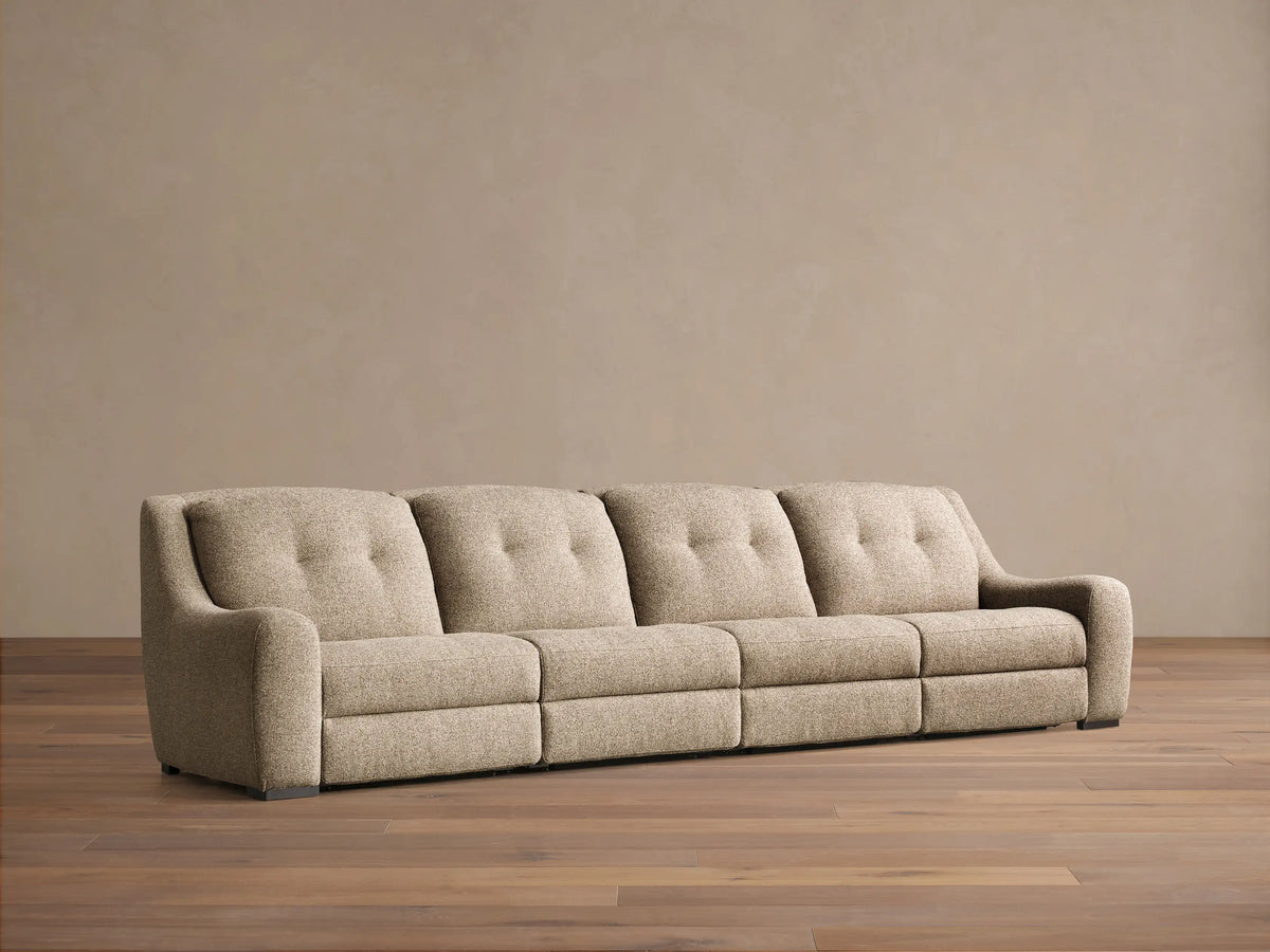 Front view of the beige tweed Perry Four-Piece Motion Sectional with four seats, tufted backs, and wide arms.
