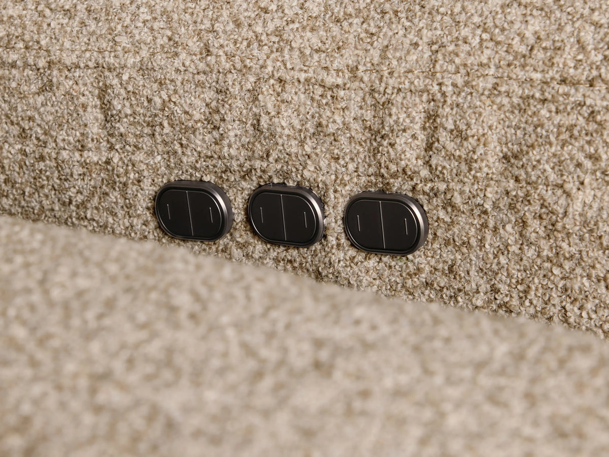 Front view of the beige speckled Perry Four-Piece Motion Sectional, featuring four tufted back cushions and armrests.