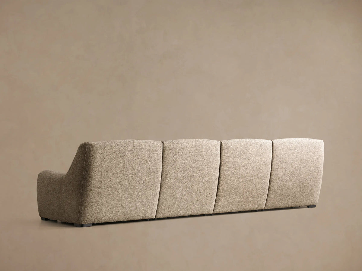 Close-up of the beige Perry Four-Piece Motion Sectional, showing a tufted back cushion and an extended footrest.