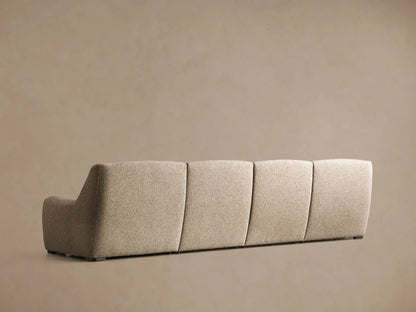 Close-up of the beige Perry Four-Piece Motion Sectional, showing a tufted back cushion and an extended footrest.