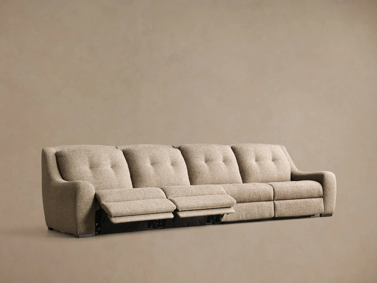 Front view of the light beige Perry Four-Piece Motion Sectional, with tufted back cushions and two right sections reclined.