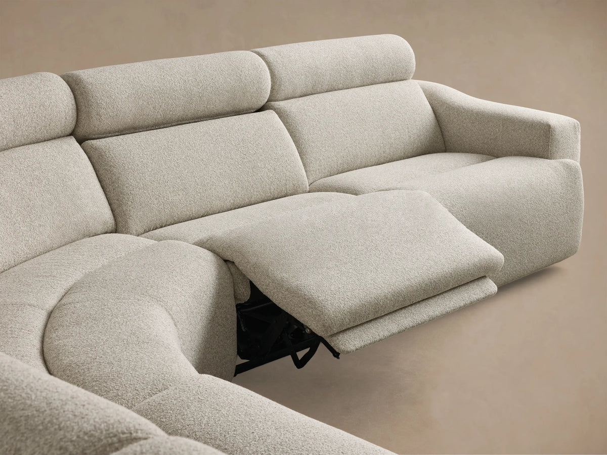 Close-up of the light grey textured fabric of the Fia Five-Piece Motion Corner Sectional with two black motion control buttons.