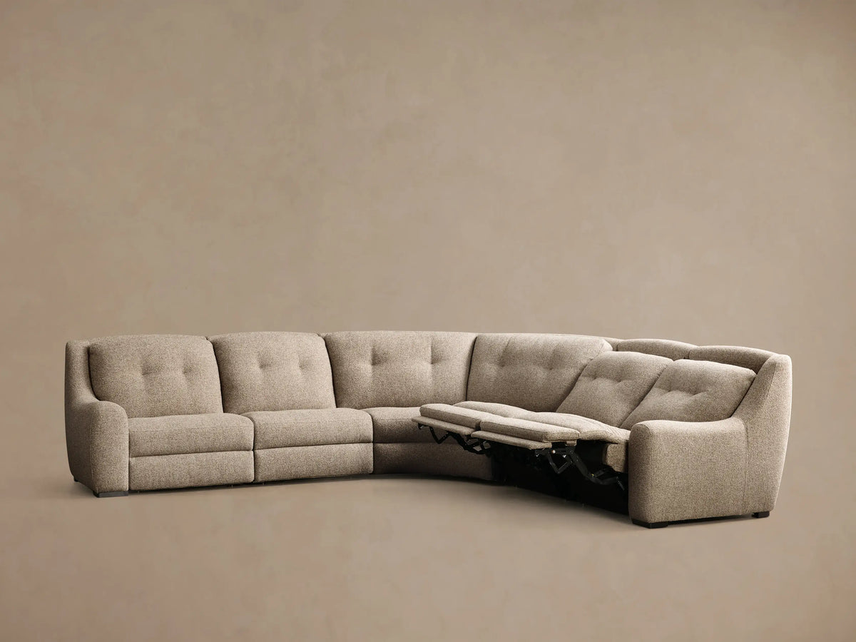 Rear view of the light beige, textured Perry Five-Piece Motion Corner Sectional, featuring a gently curved, segmented back.