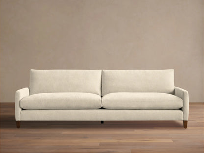 Front view of a light beige Kipton Slim Arm Elevated Sofa with slim arms and dark mocha finish legs.