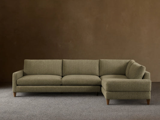 Front view of the L-shaped Kipton Slim Arm Elevated Two-Piece Sectional, upholstered in olive green patterned fabric, with slim arms and mocha feet.