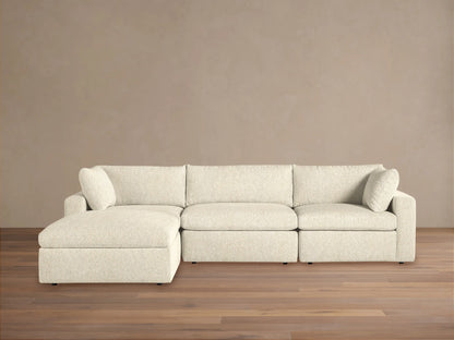 Beale Four-Piece Sectional sofa in light cream textured fabric, with a left-facing chaise lounge, against a beige wall.