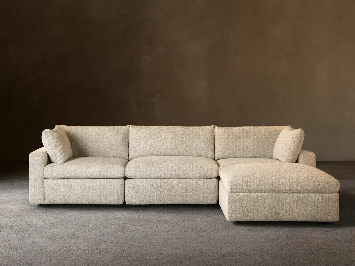 Beale Four-Piece Sectional sofa in light cream textured fabric, with a left-facing chaise lounge, against a beige wall.