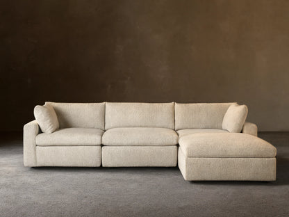 Beale Four-Piece Sectional sofa in light cream textured fabric, with a left-facing chaise lounge, against a beige wall.