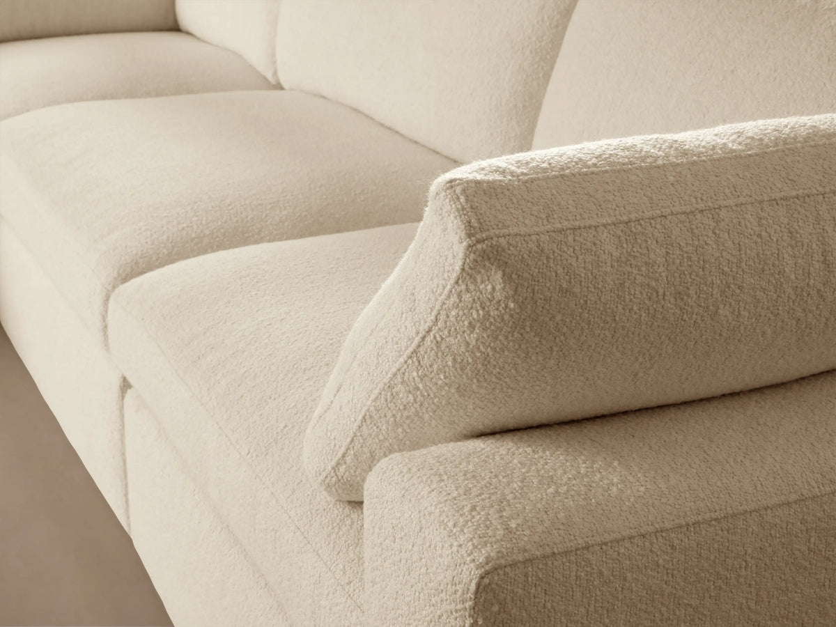 Beale Five-Piece Corner Sectional in off-white fabric against a light brown wall and wooden floor, viewed from front-right.