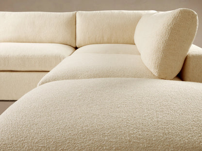 Cream Beale Five Piece Sectional, L-shaped with ottoman, relaxed style, on wooden floor against a neutral wall.