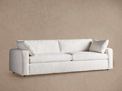 Angled close-up of the Beale Sofa, showcasing its plush, textured off-white fabric, deep seat cushions, and soft back.