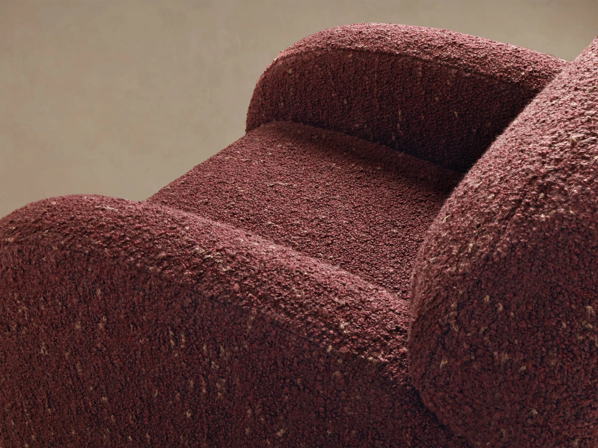 Close-up of the burgundy bouclv© fabric texture on the Algiers Swivel Chair.
