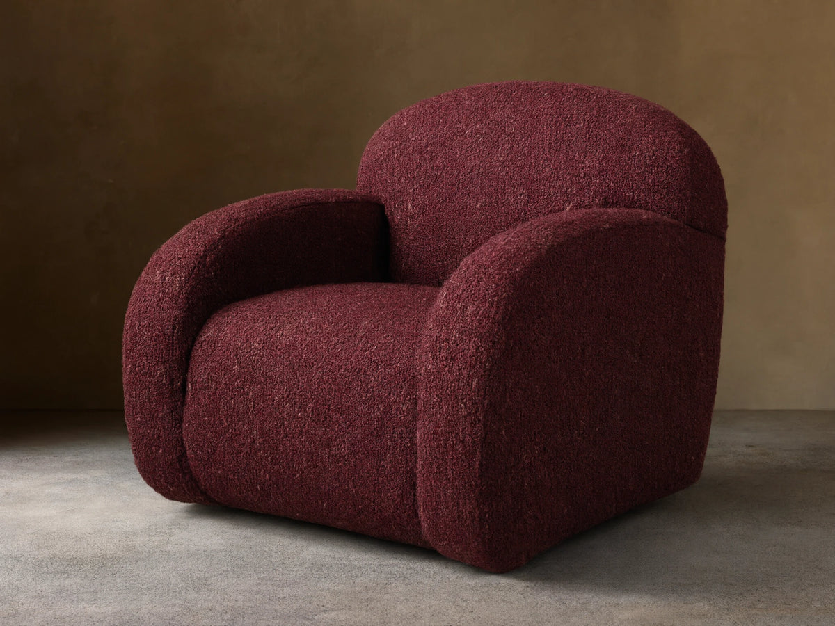 Front view of the burgundy Algiers Swivel Chair, upholstered in a textured fabric with a rounded, modern design.
