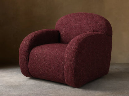 Front view of the burgundy Algiers Swivel Chair, upholstered in a textured fabric with a rounded, modern design.