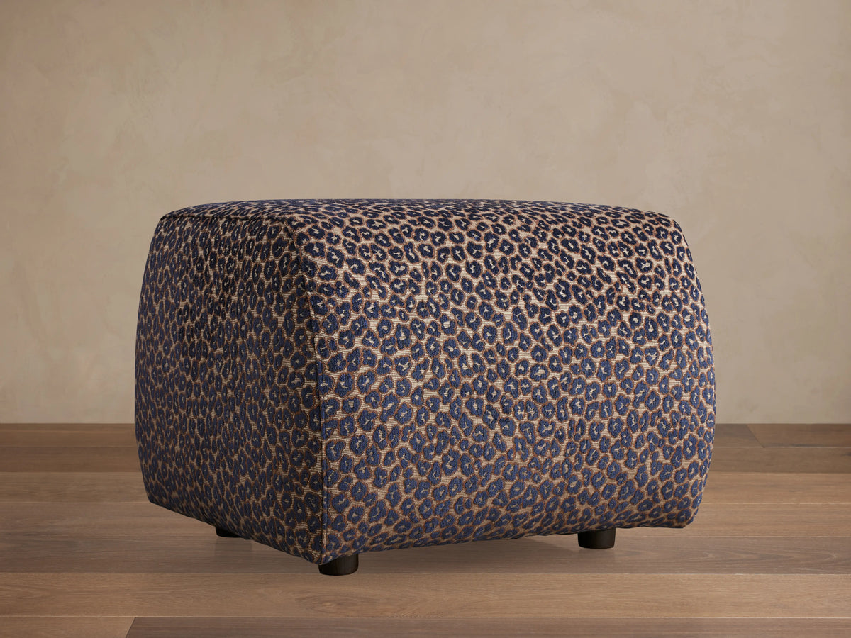 Front view of Fresno Ottoman, a beige, brown, and gray woven cube ottoman with a checkerboard pattern.