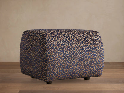 Front view of Fresno Ottoman, a beige, brown, and gray woven cube ottoman with a checkerboard pattern.