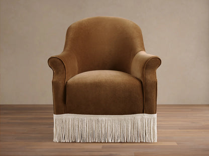Front view of a caramel Augustus Chair with Fringe, featuring rolled arms and a cream fringe along the bottom base.
