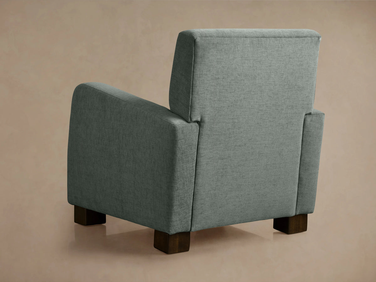Kershaw Chair in textured gray fabric, featuring wide padded armrests and a cushioned backrest, set against a neutral background.