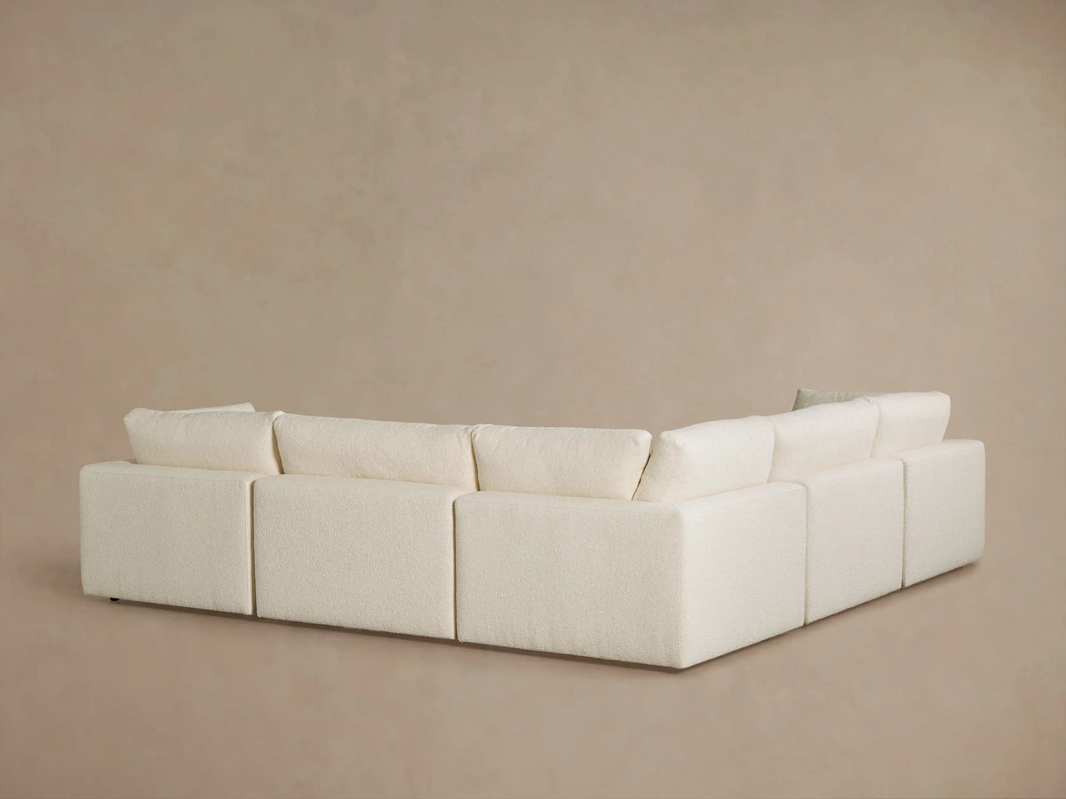Close-up of a cream boucle Beale Corner Sectional, showing plush seat and back cushions and an armrest.