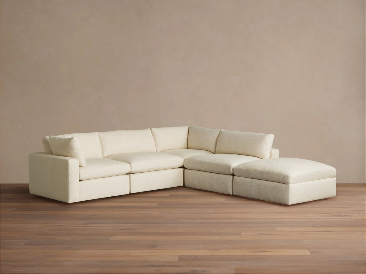 Cream-colored Beale Five Piece Sectional, L-shaped, with plush textured fabric, on wood floor against a neutral wall.