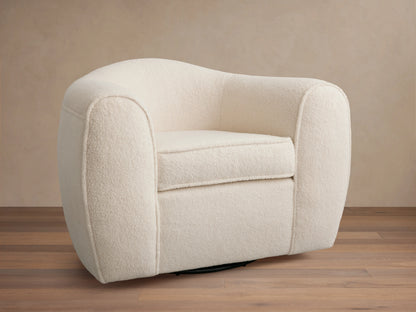 Cream-colored Barret Chair with plush, rounded armrests and backrest. Features a soft fabric texture and a solid base for swivel rotation.