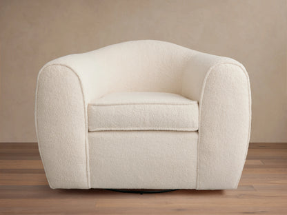 Cream-colored Barret Chair with plush, rounded armrests and backrest. Features a soft fabric texture and a solid base for swivel rotation.