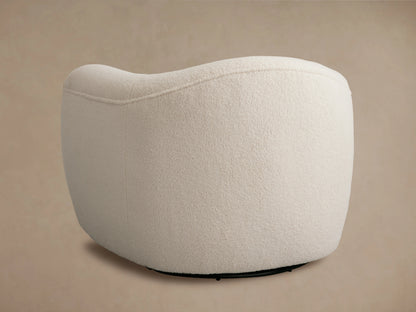 Curved armrest of the Barret Chair in soft white textured fabric, showcasing plush cushioning and smooth contour.