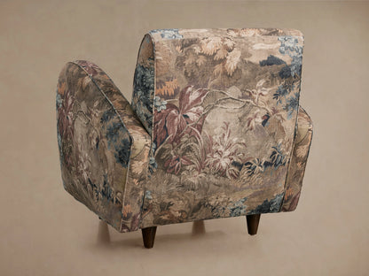Myrtle Chair with floral patterned upholstery in shades of brown, blue, and rust. Features contrasting welt detail on armrests.