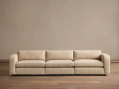 Front view of the beige Stiles Three-Piece Modular Sofa, featuring rounded arms and deep, plush cushions.