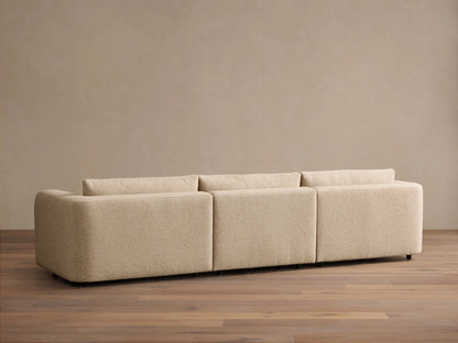 Rear view of the beige Stiles Three-Piece Modular Sofa, showing its three modular sections and textured fabric.