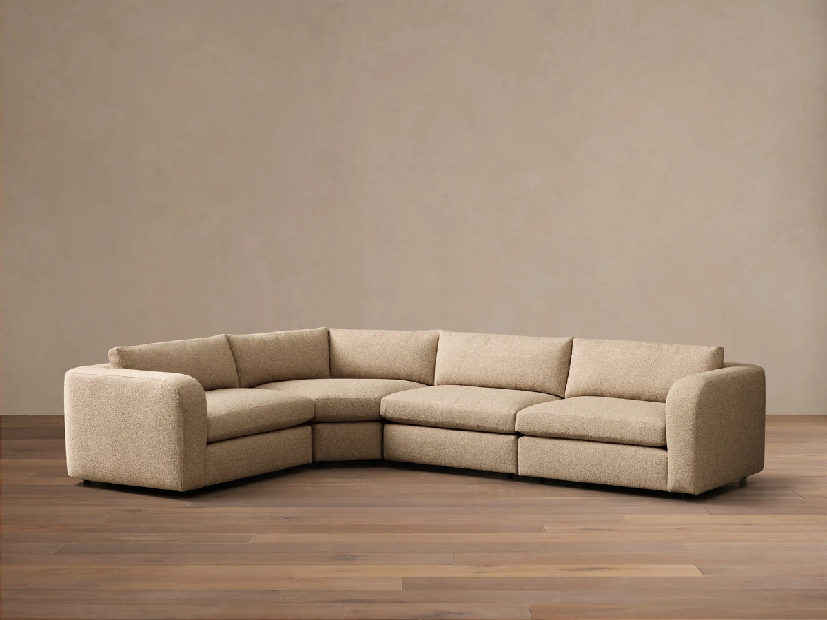 Front view of a light beige Stiles Four-Piece Sectional™ in an L-shape, with left arm, corner, armless, and right arm units.
