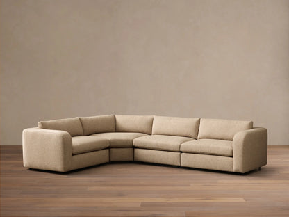 Front view of a light beige Stiles Four-Piece Sectional™ in an L-shape, with left arm, corner, armless, and right arm units.