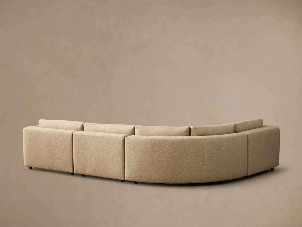 Close-up of the beige textured fabric on the armrest and back cushion of the Stiles Four-Piece Sectional.